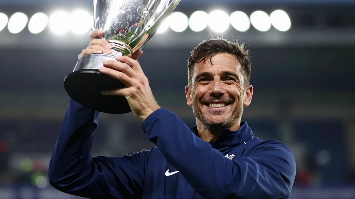 Mjallby assistant coach Karl Marius Aksum celebrated with the trophy after the team's Allsvenskan match against Häcken in...